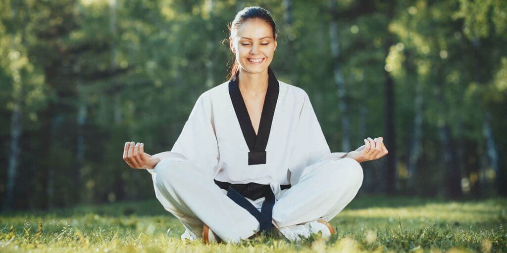 Martial Arts Lessons for Adults in Frisco TX - Happy Woman Meditated Sitting Background